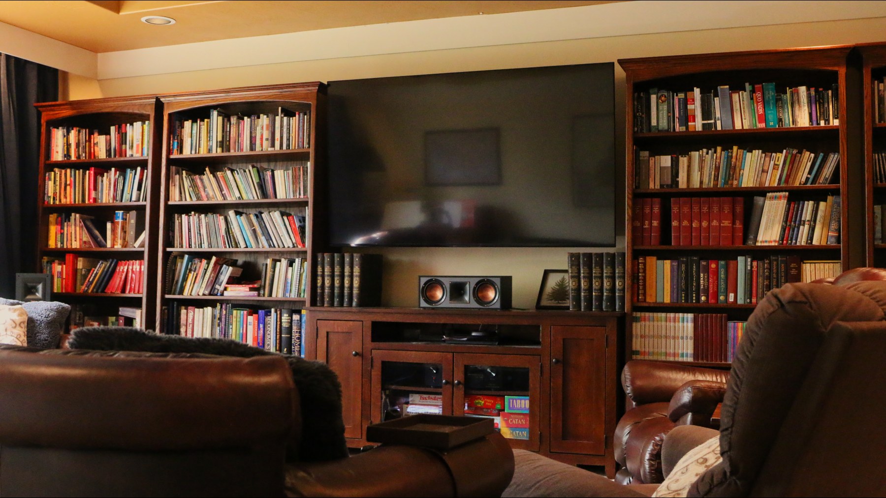 Bookshelves, media wall, and seating in the finished Grayham Industries media room